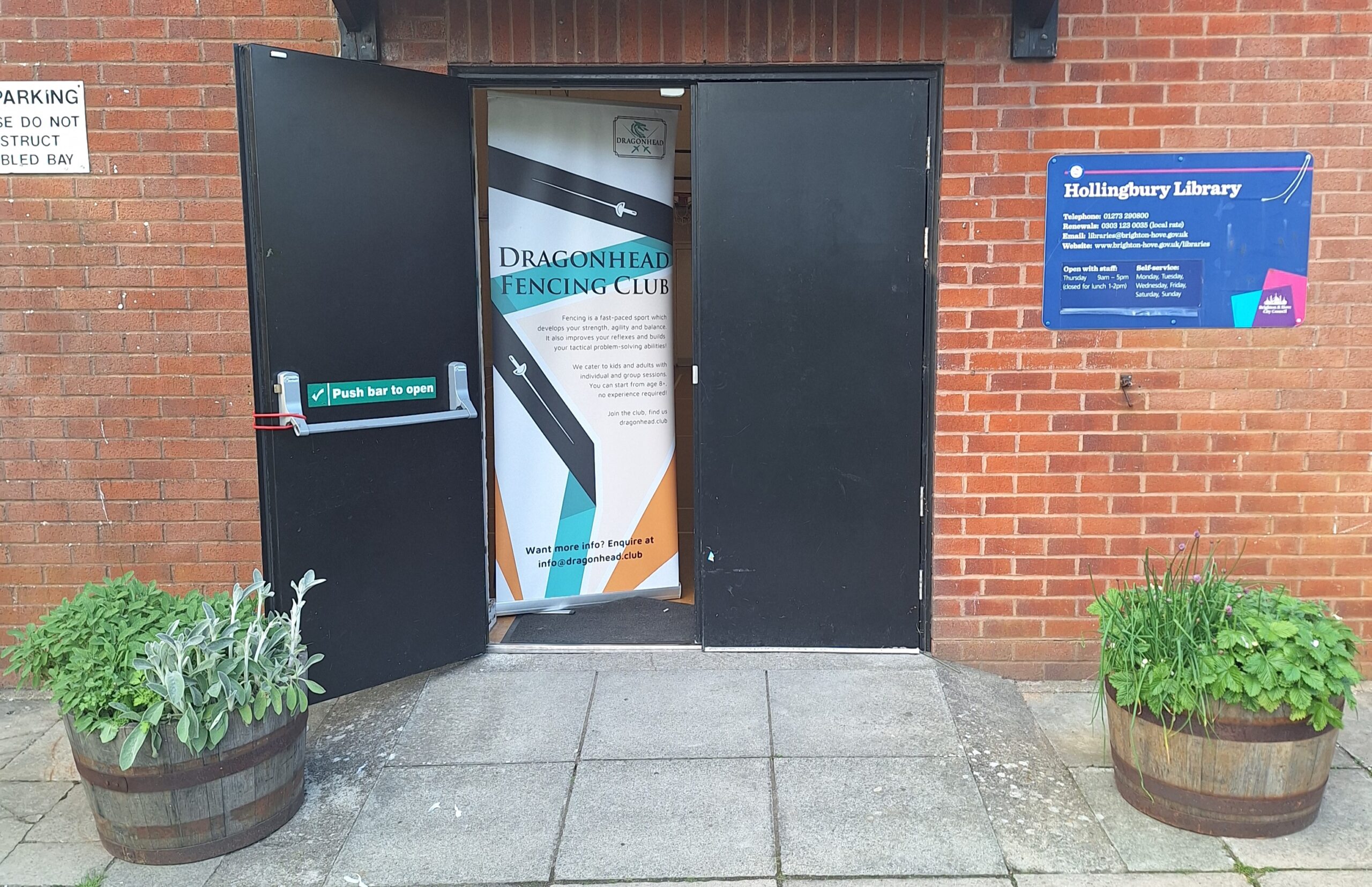 a banner for Dragonhead fencing club in the doorway of the sports hall venue at Hollingbury Library